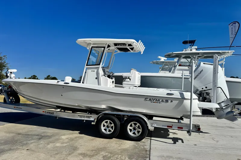 Slide: The Image of 2026 Caymas 28 HB boat on trailer under clear blue sky. - 3