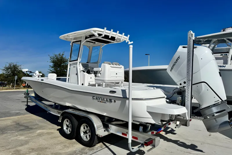 Slide: The Image of 2026 Caymas 28 HB boat on trailer with Mercury engine, parked outdoors. - 4