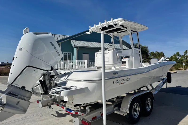Slide: The Image of 2026 Caymas 28 HB boat on trailer with Mercury outboard engine, parked outdoors. - 7