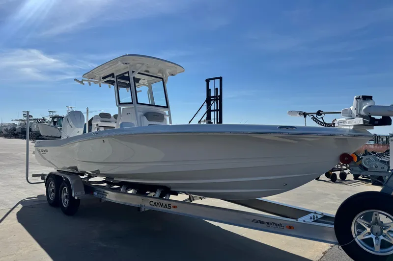 Slide: The Image of 2026 Caymas 28 HB boat on trailer under clear blue sky. - 8