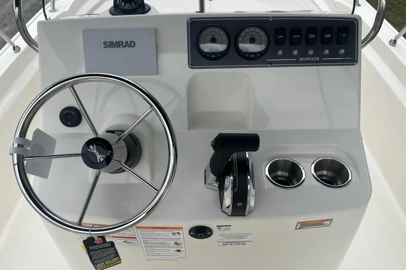Slide: The Image of 2026 Boston Whaler 190 Montauk boat console with steering wheel and controls. - 15