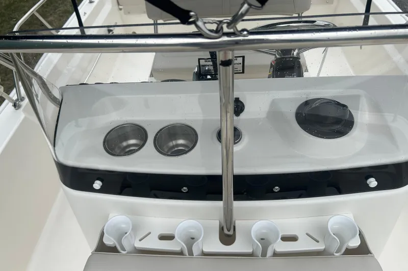 Slide: The Image of 2026 Boston Whaler 190 Montauk boat console with cup holders and controls. - 17