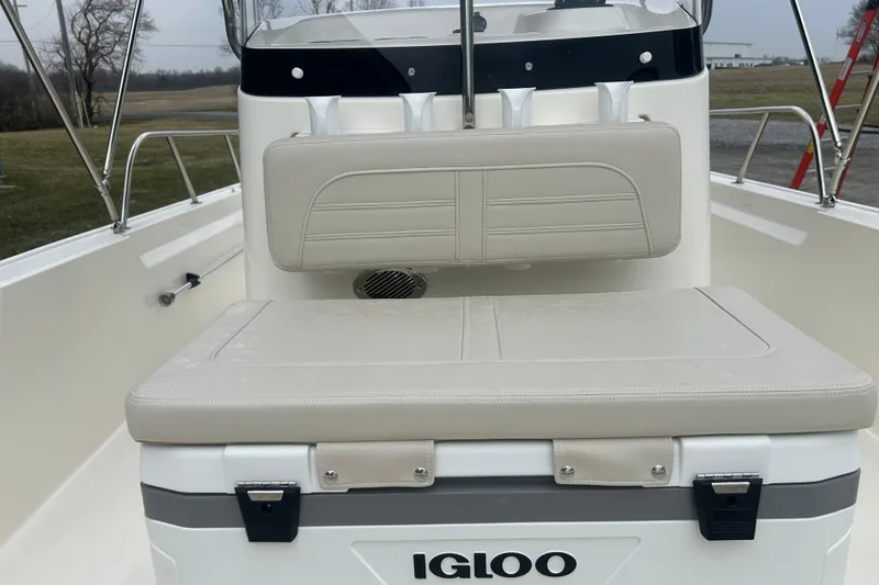 Slide: The Image of 2026 Boston Whaler 190 Montauk boat interior with Igloo cooler and cushioned seating. - 20