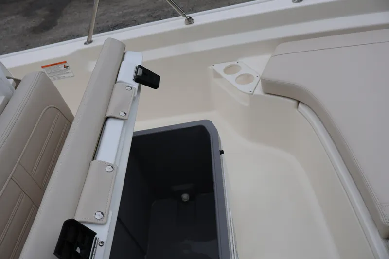 Slide: The Image of 2026 Boston Whaler 190 Montauk boat interior with storage compartment and cup holders. - 22