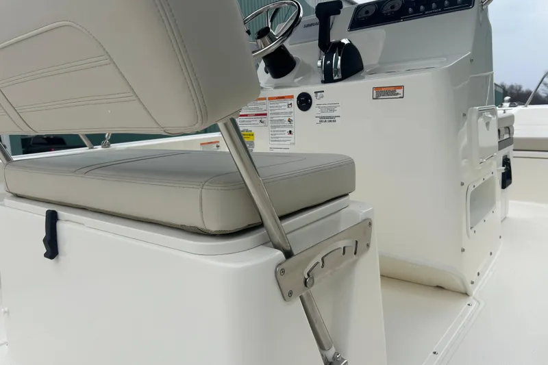 Slide: The Image of 2026 Boston Whaler 190 Montauk boat interior with steering console and cushioned seating. - 25
