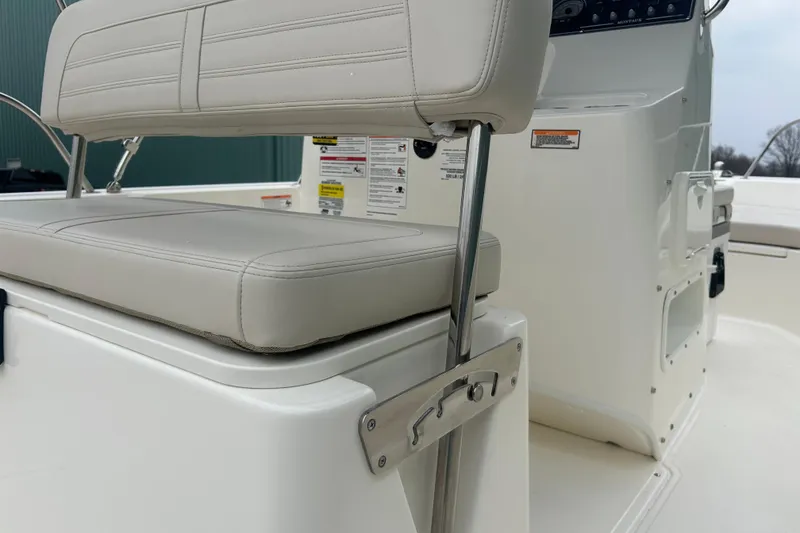 Slide: The Image of 2026 Boston Whaler 190 Montauk boat interior, featuring cushioned seating and control panel. - 28