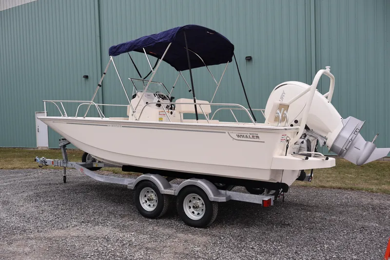 Slide: The Image of 2026 Boston Whaler 190 Montauk boat on trailer, parked outdoors. - 8