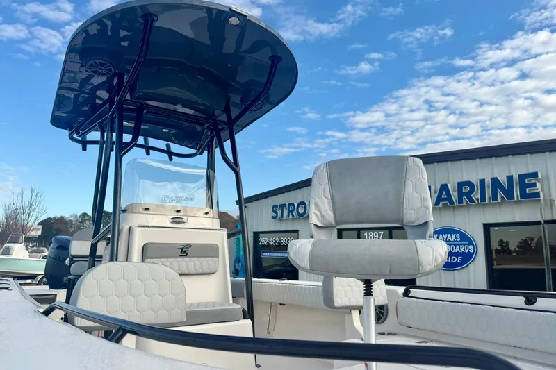 Slide: The Image of 2026 Carolina Skiff 26 Ultra Elite boat with seating, displayed at a marine dealership. - 11