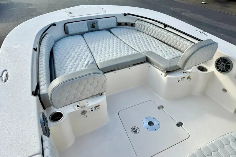 Slide: The Image of 2026 Carolina Skiff 26 Ultra Elite boat interior with cushioned seating and cup holders. - 13