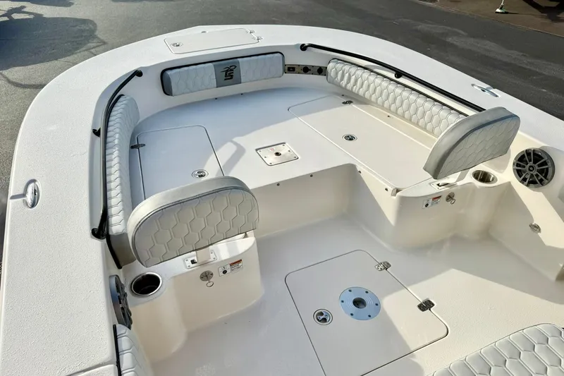 Slide: The Image of 2026 Carolina Skiff 26 Ultra Elite boat interior with cushioned seating and storage compartments. - 14