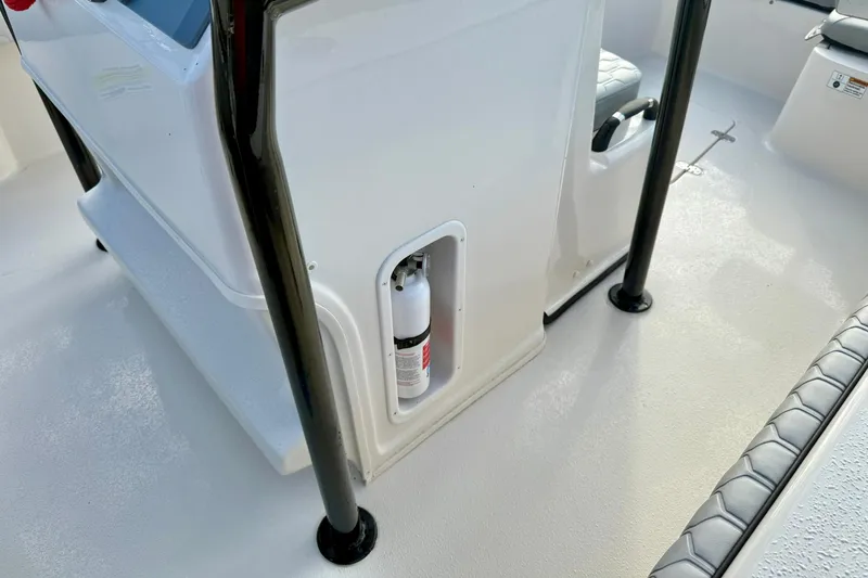 Slide: The Image of 2026 Carolina Skiff 26 Ultra Elite boat interior with fire extinguisher compartment. - 22