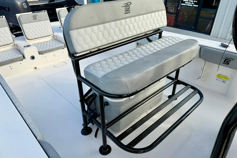 Slide: The Image of 2026 Carolina Skiff 26 Ultra Elite boat interior with cushioned seating and storage. - 24