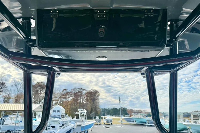 Slide: The Image of 2026 Carolina Skiff 26 Ultra Elite boat interior with overhead storage and marina view. - 27