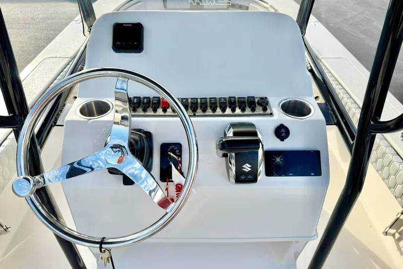 Slide: The Image of Steering console of 2026 Carolina Skiff 26 Ultra Elite boat with controls and cup holders. - 3