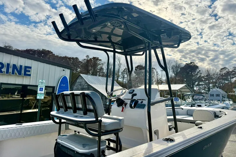Slide: The Image of 2026 Carolina Skiff 26 Ultra Elite boat at marina, featuring T-top and seating. - 31