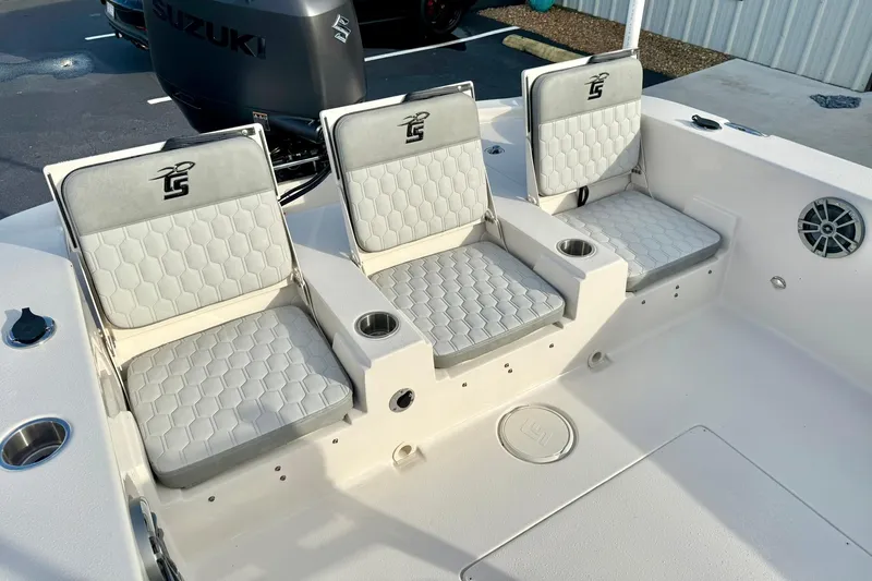 Slide: The Image of 2026 Carolina Skiff 26 Ultra Elite boat seats with cup holders and Suzuki engine. - 33