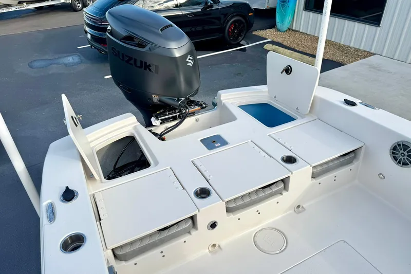 Slide: The Image of 2026 Carolina Skiff 26 Ultra Elite boat with Suzuki outboard motor, open storage compartments. - 39