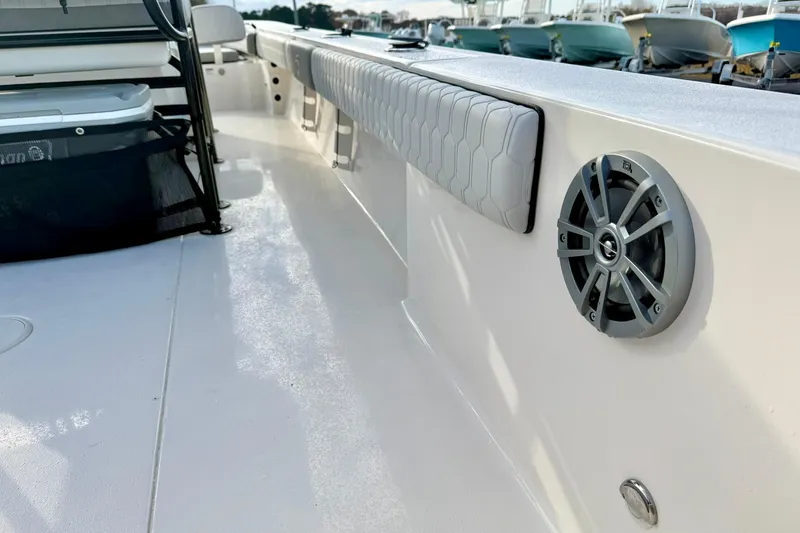 Slide: The Image of 2026 Carolina Skiff 26 Ultra Elite boat interior with speaker and cushioned seating. - 43