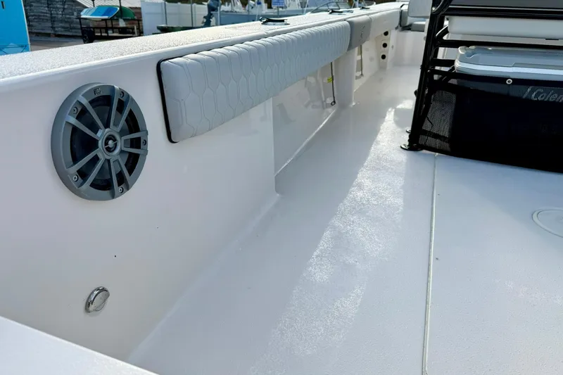 Slide: The Image of 2026 Carolina Skiff 26 Ultra Elite boat interior with speaker and cushioned seating. - 44