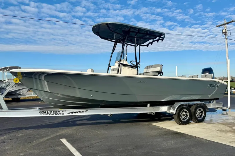 Slide: The Image of 2026 Carolina Skiff 26 Ultra Elite boat on trailer under blue sky. - 5