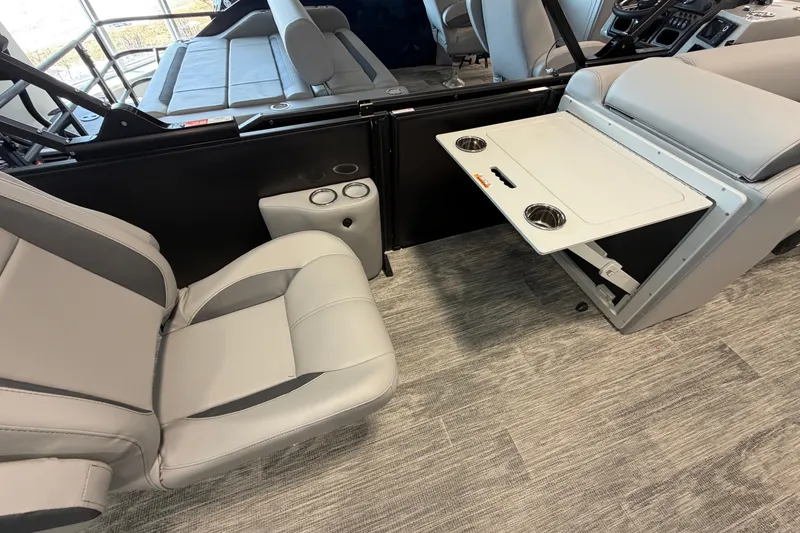 Slide: The Image of 2026 Bentley Pontoons Legacy 243 Swingback interior with seating and fold-out table. - 13
