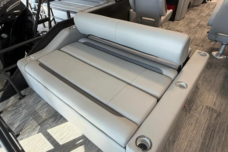 Slide: The Image of 2026 Bentley Pontoons Legacy 243 Swingback interior seating with cup holders, showcasing luxury design. - 3