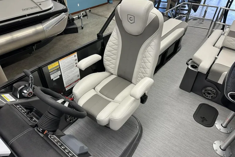 Slide: The Image of Captain's chair and helm of 2026 Godfrey Monaco 235 SFL pontoon boat. - 6