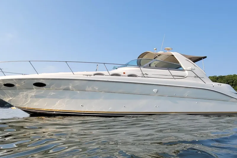 The Image of 1995 Sea Ray 370 Sundancer yacht on calm water under clear blue sky. - 0