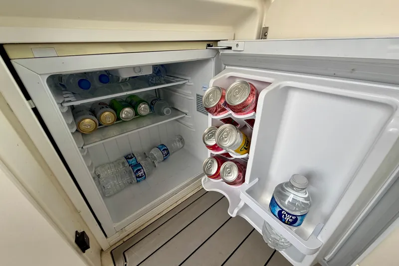 Slide: The Image of Mini fridge stocked with drinks on a 1995 Sea Ray 370 Sundancer boat. - 11