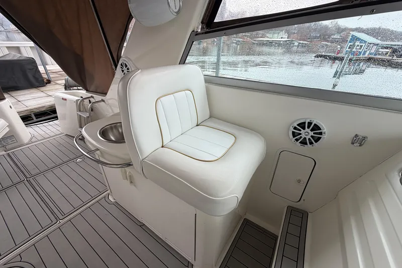 Slide: The Image of 1995 Sea Ray 370 Sundancer interior with white seating and a view of the marina. - 12