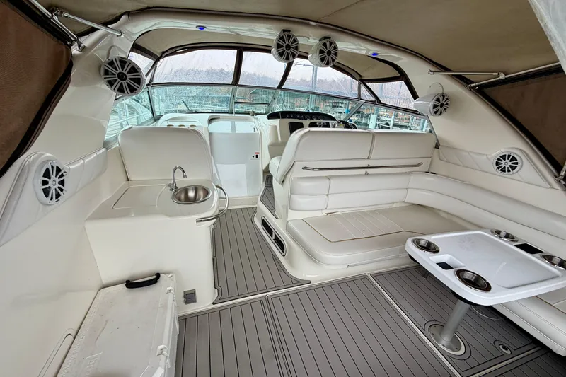 Slide: The Image of Interior of a 1995 Sea Ray 370 Sundancer yacht with seating and a small sink. - 13