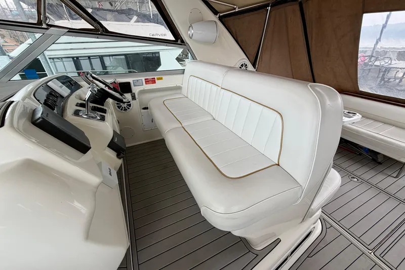 Slide: The Image of Interior of a 1995 Sea Ray 370 Sundancer boat with white seating and helm. - 14
