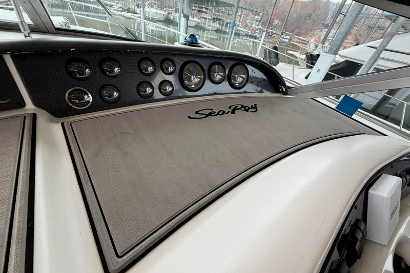 Slide: The Image of Dashboard of a 1995 Sea Ray 370 Sundancer boat with gauges and logo. - 17