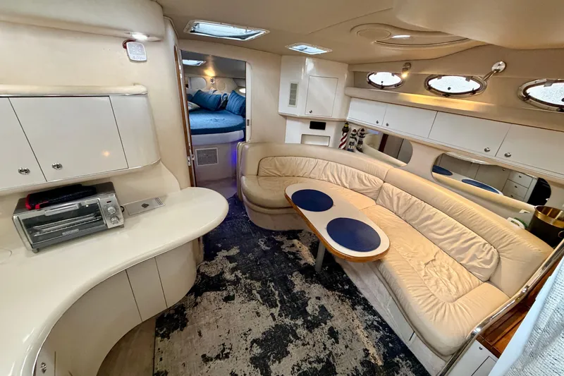 Slide: The Image of Luxurious interior of a 1995 Sea Ray 370 Sundancer yacht with cozy seating and modern amenities. - 21