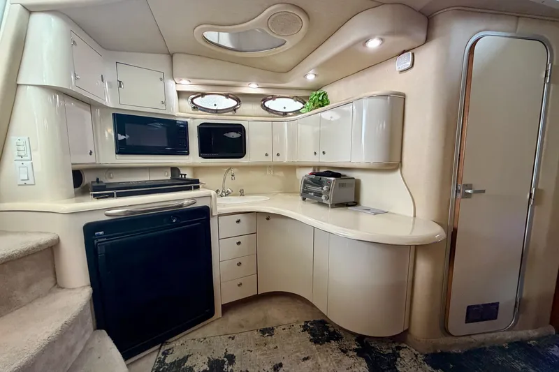 Slide: The Image of Luxurious 1995 Sea Ray 370 Sundancer yacht interior kitchen with modern amenities. - 23