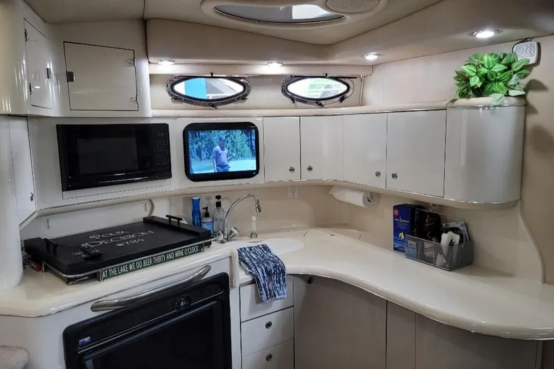 Slide: The Image of Luxurious 1995 Sea Ray 370 Sundancer yacht kitchen with modern amenities and elegant design. - 24