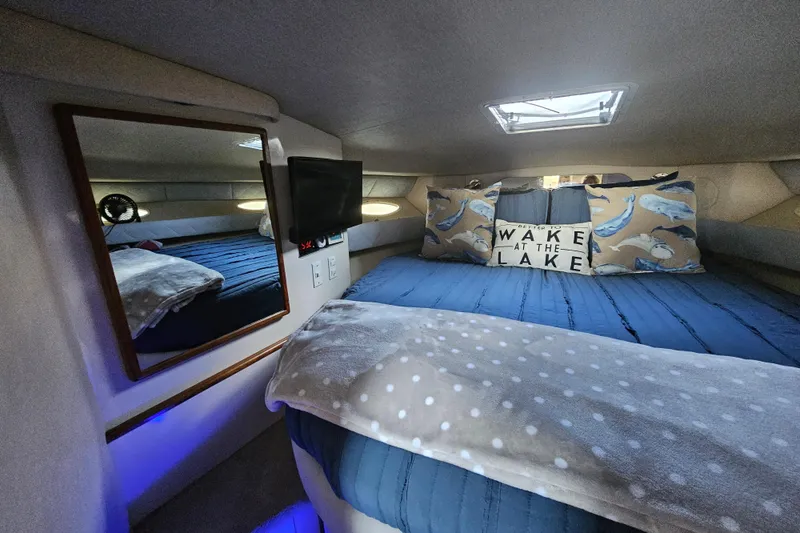 Slide: The Image of Cozy cabin interior of 1995 Sea Ray 370 Sundancer with nautical decor and bedding. - 27