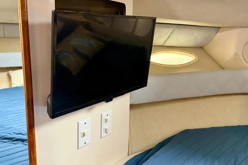 Slide: The Image of Interior of 1995 Sea Ray 370 Sundancer with mounted TV and porthole window. - 30