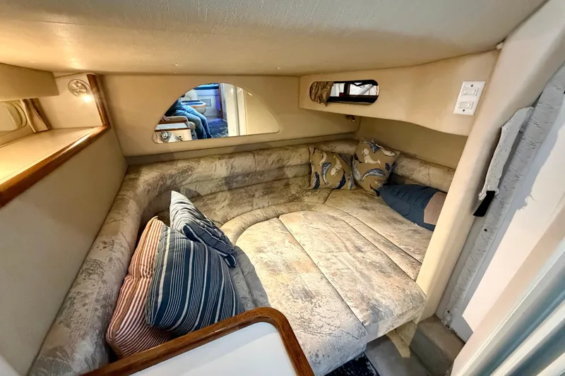 Slide: The Image of Cozy cabin interior of 1995 Sea Ray 370 Sundancer with plush seating and pillows. - 33