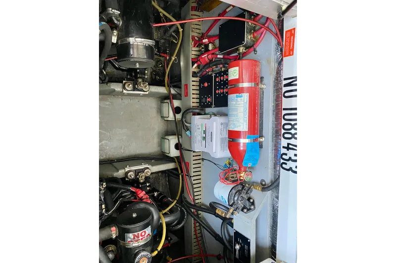 Slide: The Image of Engine compartment of a 1995 Sea Ray 370 Sundancer with fire extinguisher and wiring. - 37