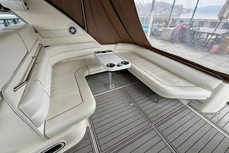 Slide: The Image of Luxurious interior of 1995 Sea Ray 370 Sundancer with white seating and table. - 7