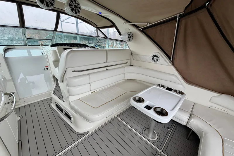 Slide: The Image of 1995 Sea Ray 370 Sundancer interior with white seating and table, featuring modern design elements. - 8