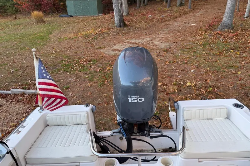 Slide: The Image of 2004 Grady-White Fisherman 180 with Yamaha 150 engine and American flag, autumn setting. - 11