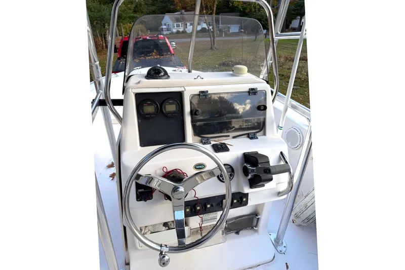 Slide: The Image of 2004 Grady-White Fisherman 180 boat console with steering wheel and controls. - 9