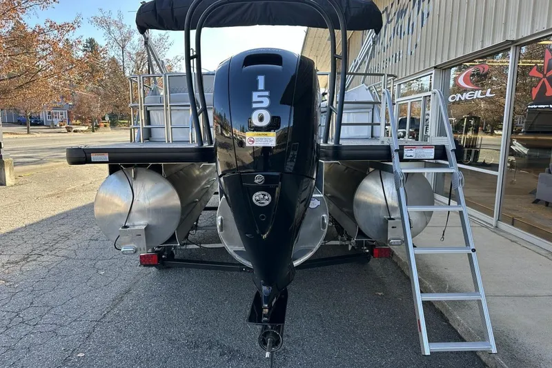 Slide: The Image of 2026 Godfrey Sweetwater 2286 SFLC pontoon boat with powerful 150 engine, parked outdoors. - 3
