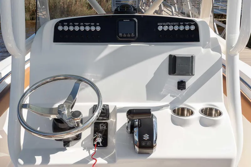 Slide: The Image of Manufacturer Provided Image: 2025 Pioneer 222 Islander boat console with steering wheel, controls, and cup holders. - 11