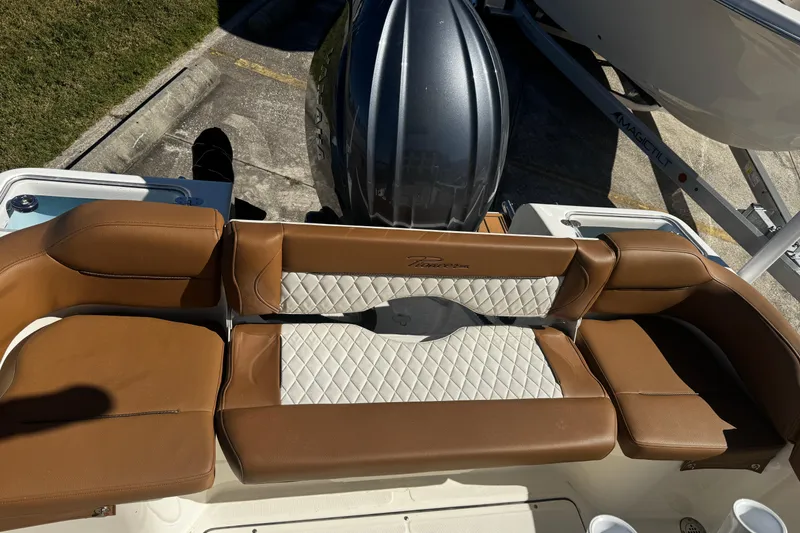 Slide: The Image of 2026 Pioneer 222 Islander boat with brown and white cushioned seating. - 15
