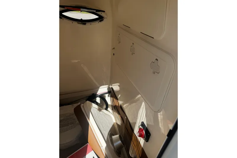 Slide: The Image of Interior of 2026 Pioneer 222 Islander boat, featuring storage compartments and seating. - 22