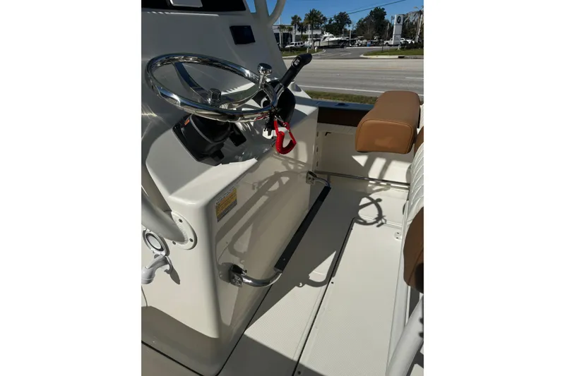 Slide: The Image of 2026 Pioneer 222 Islander boat interior with steering wheel and seating. - 24