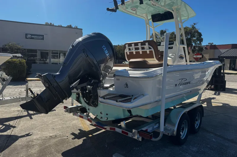 Slide: The Image of 2026 Pioneer 222 Islander boat with Yamaha engine on trailer, outdoor dealership setting. - 3